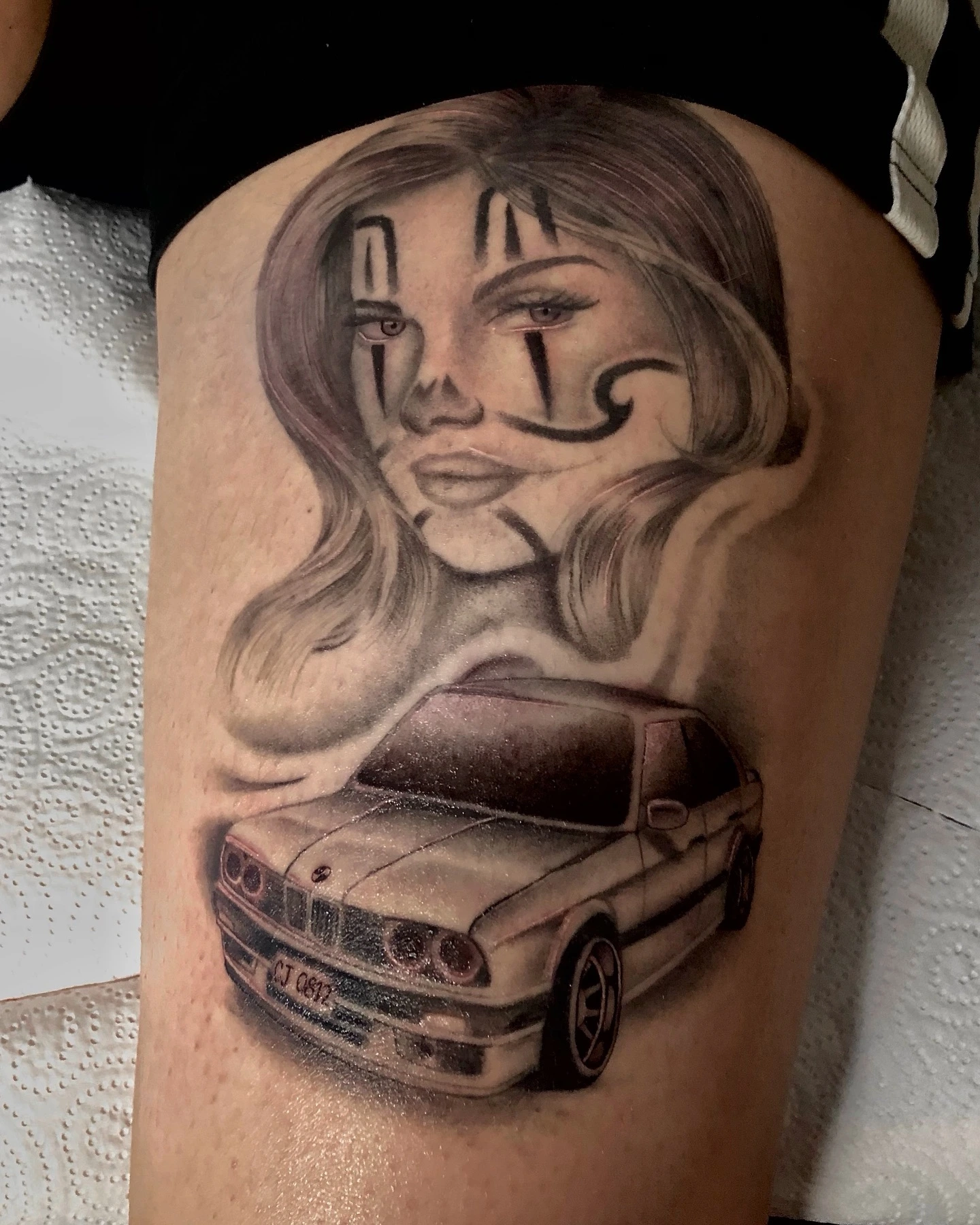 Chicano-style woman with clown makeup over a BMW E30 car