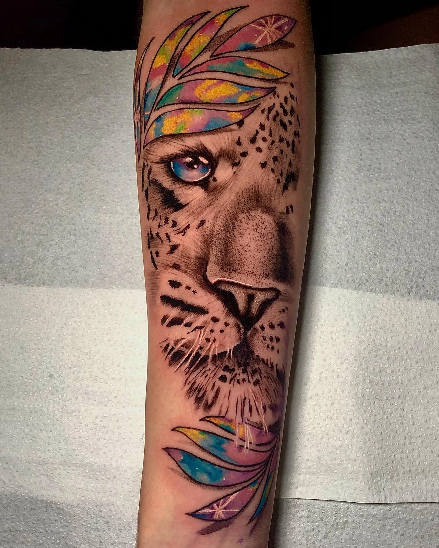 Leopard/lion face with rainbow watercolor leaves