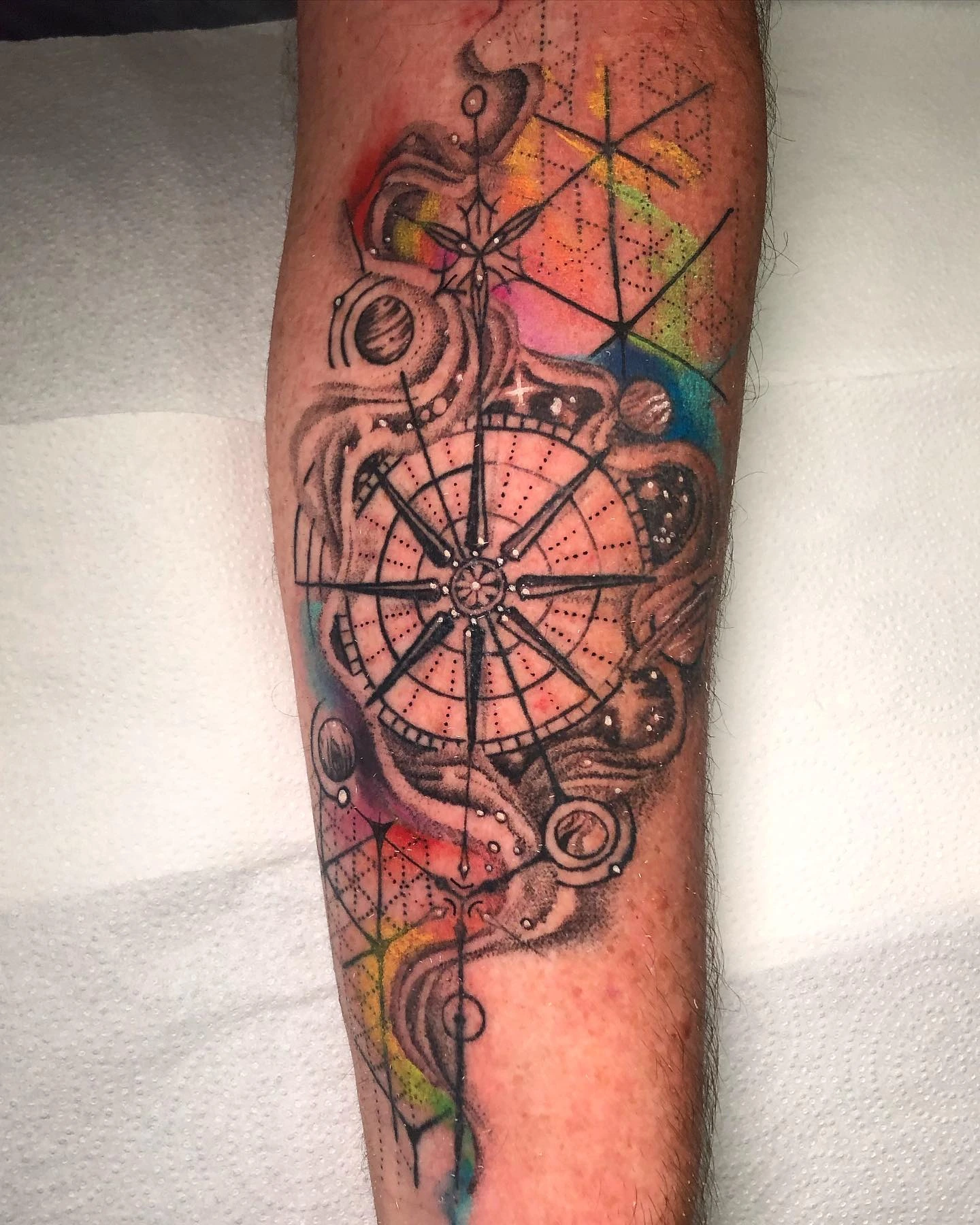 Compass/cosmic mandala with planets and rainbow watercolor splash background
