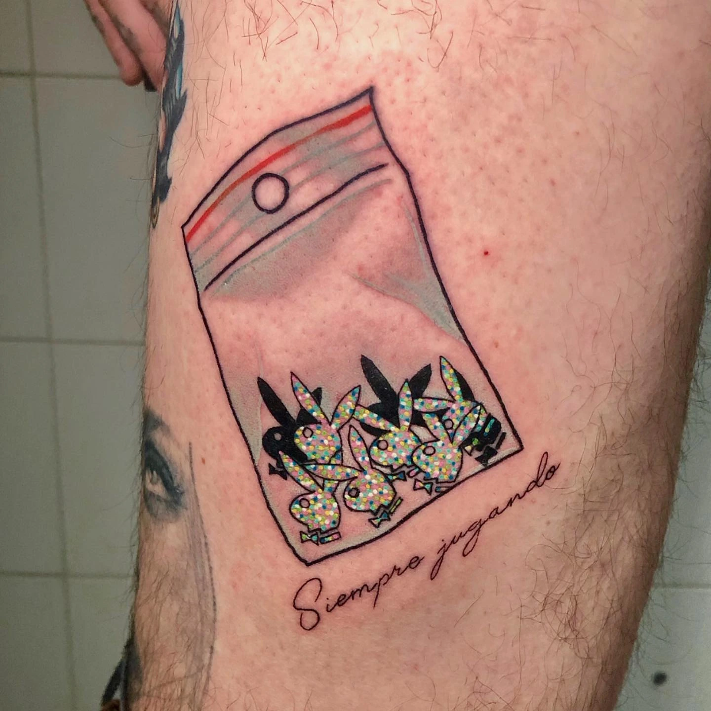 Baggie of glittery Playboy bunnies with 'Siempre jugando' script