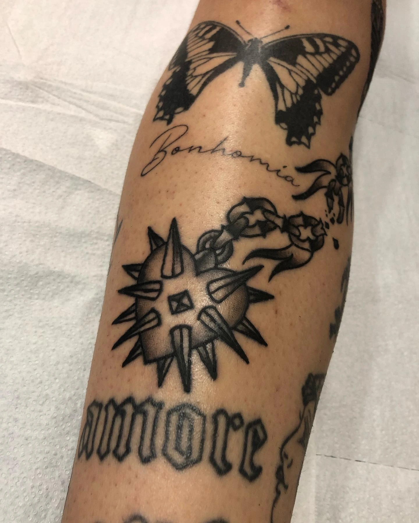 Spiked mace, butterfly, blackletter 'amore' lettering