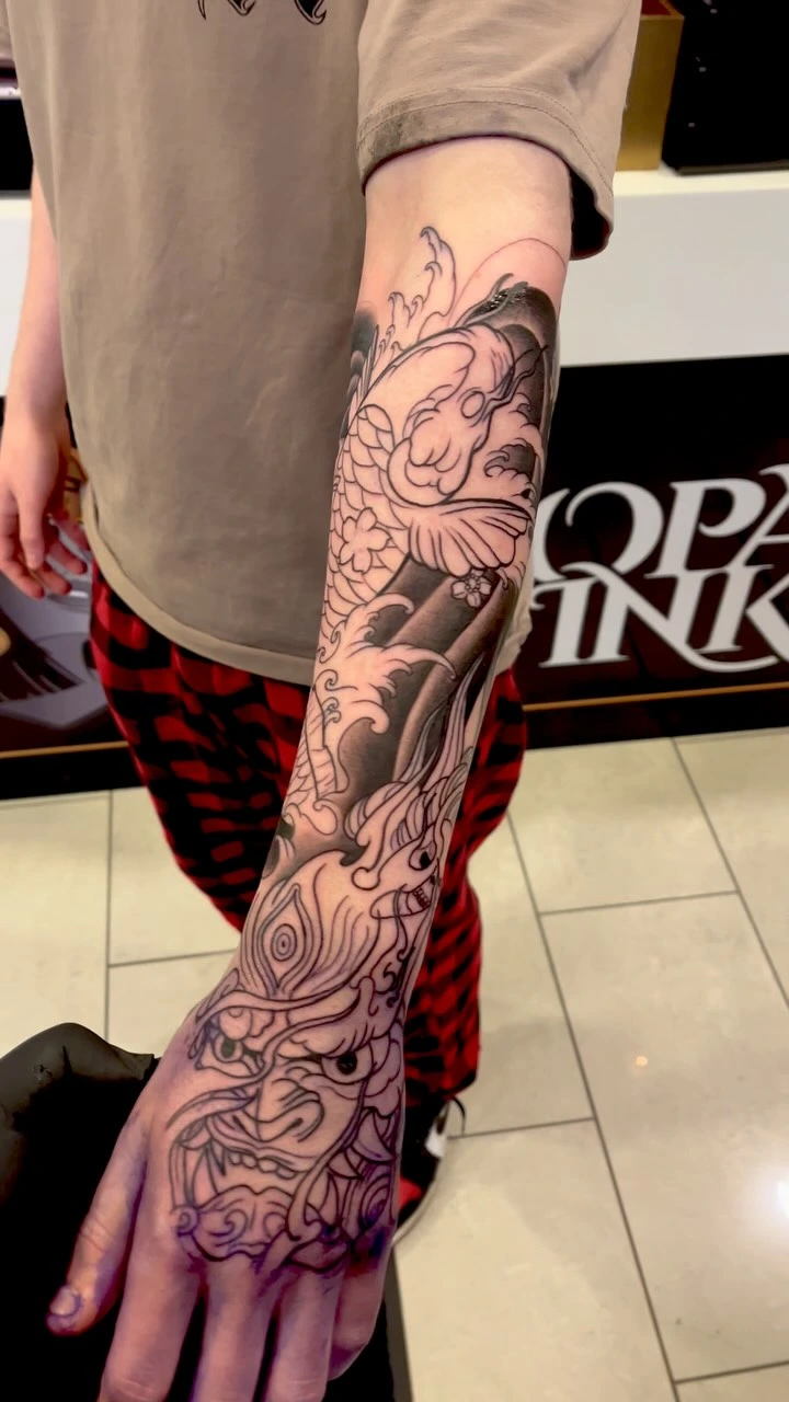 First session Japanese sleeve linework: hannya hand, dragon, waves, flowers