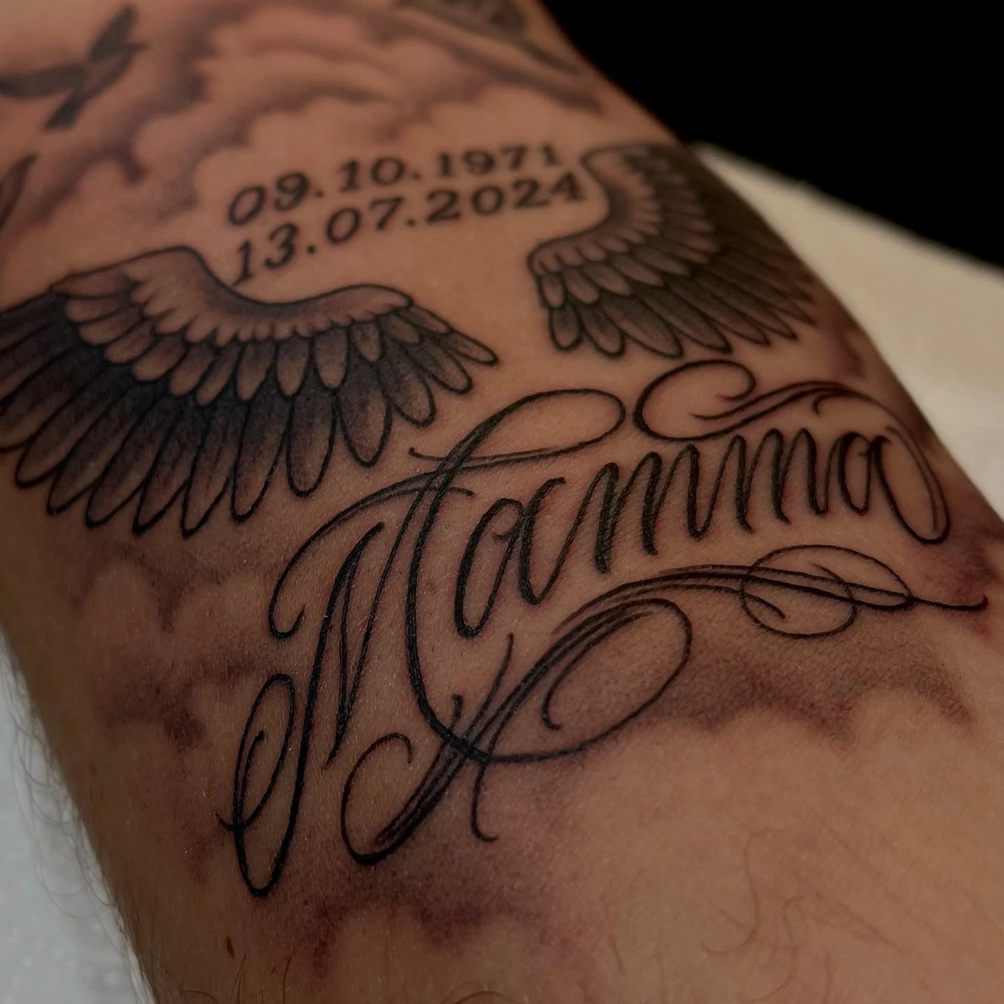 Detail of Mamma memorial script and wings