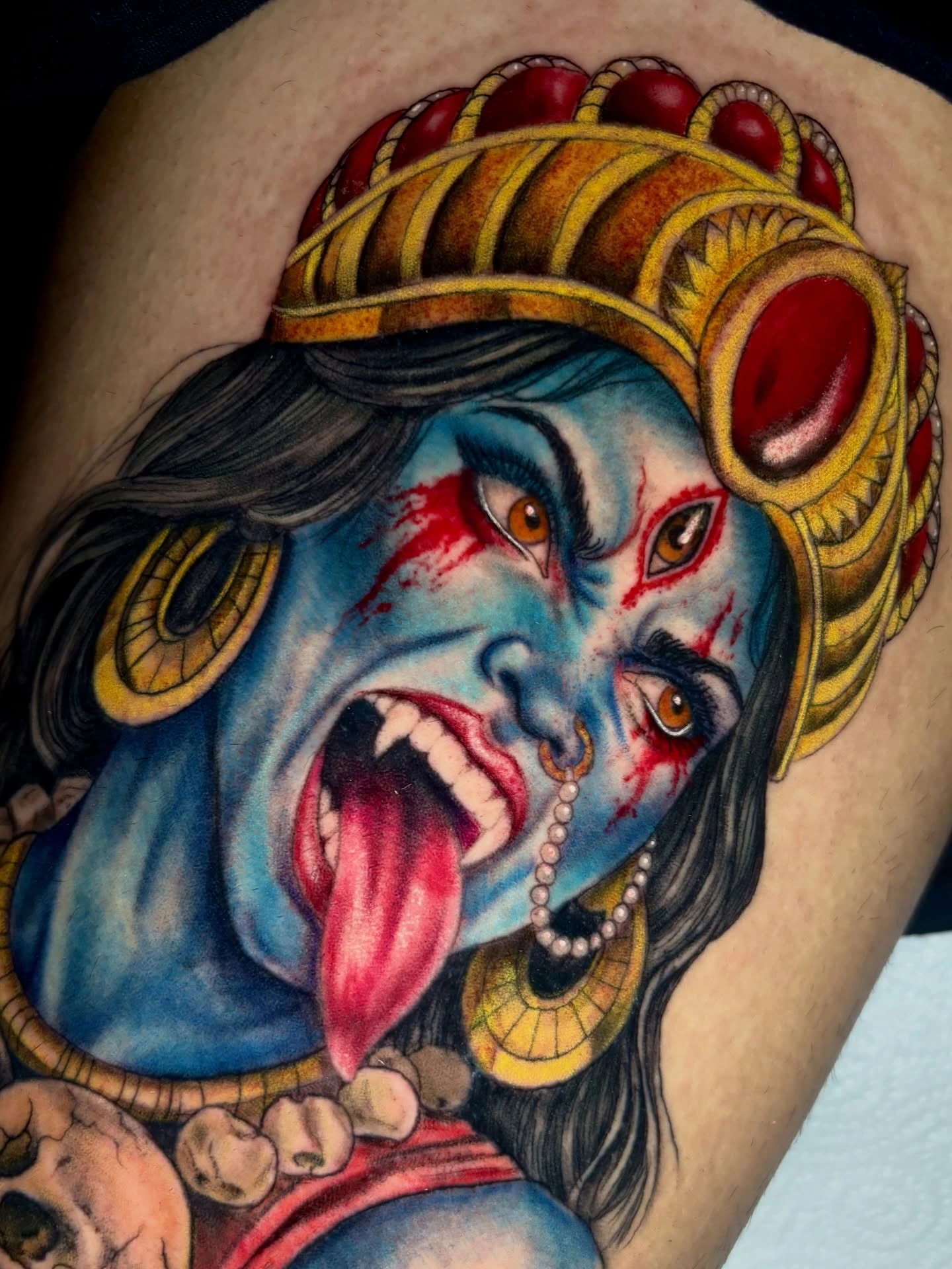 Kali goddess close-up — face, fangs, tongue