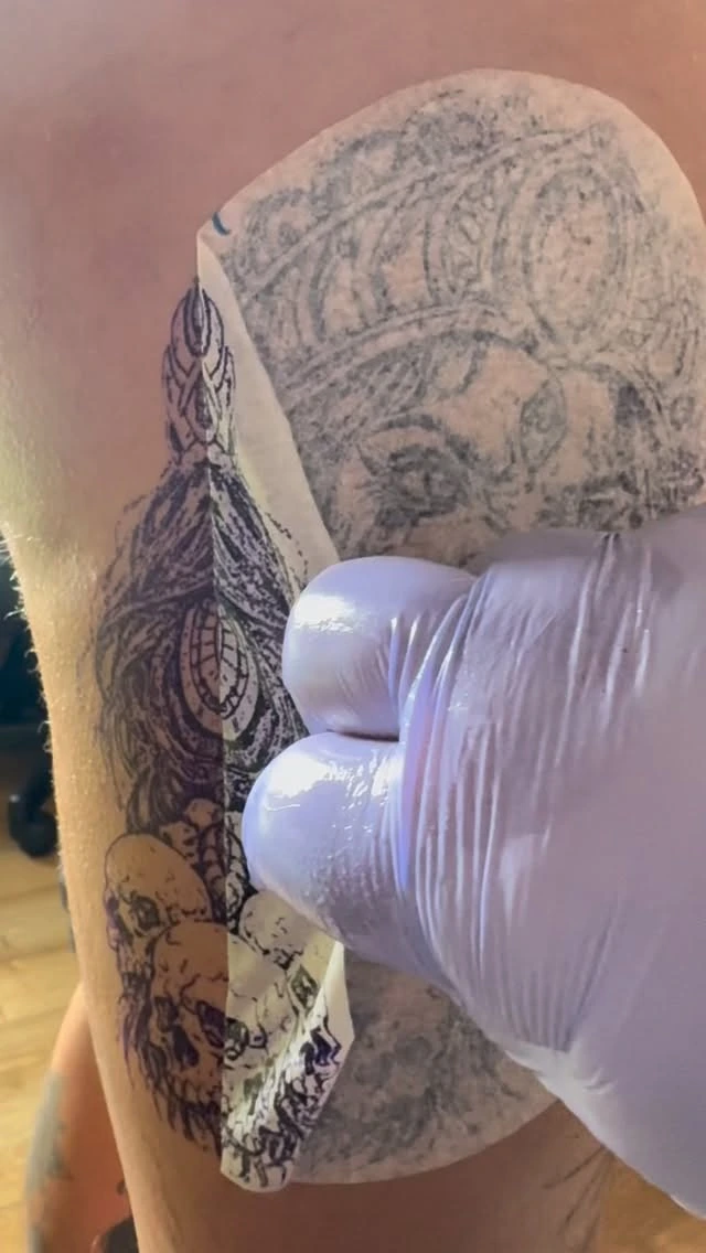 Stencil with Saran-wrap aftercare on a healing piece