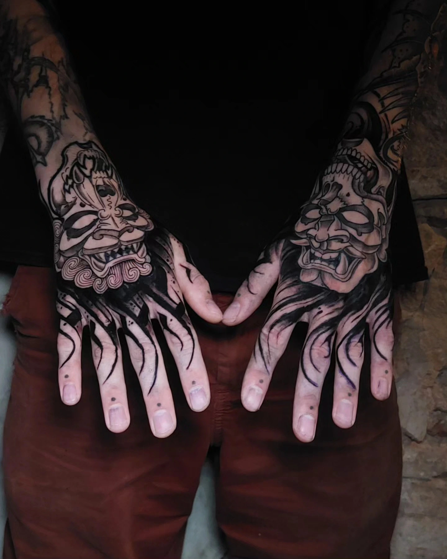 Pair of hannya masks across both hands with flame fingers
