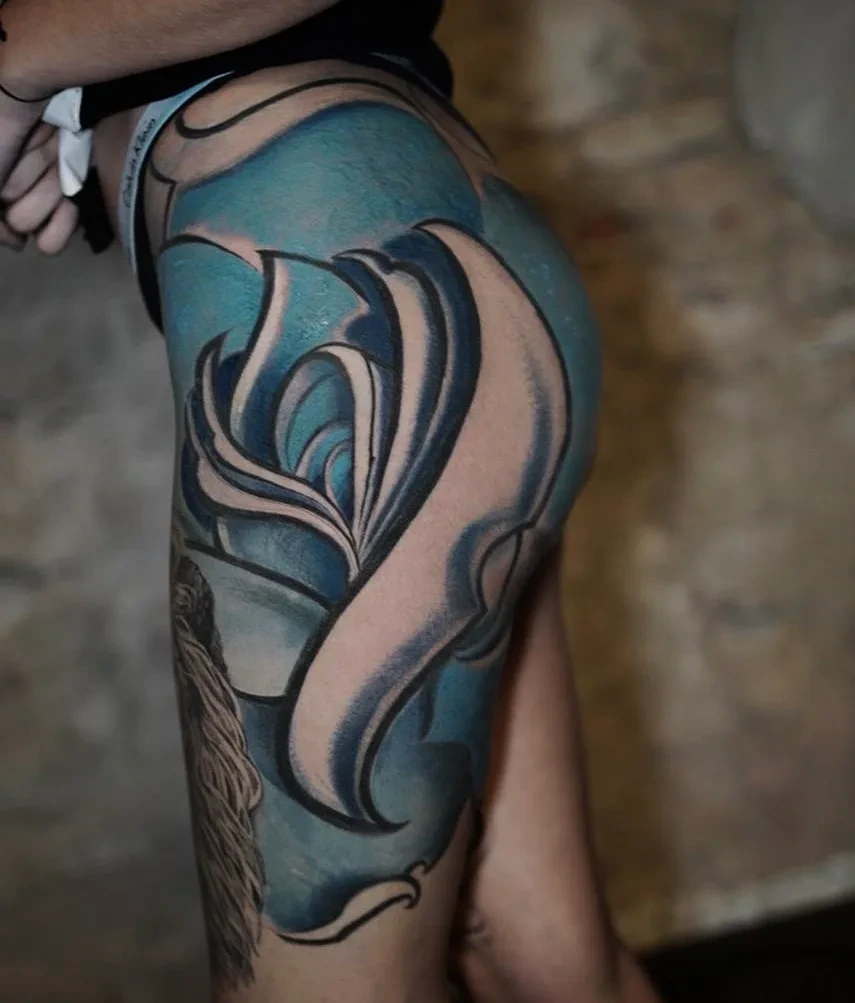 Saturated blue rose on hip/thigh