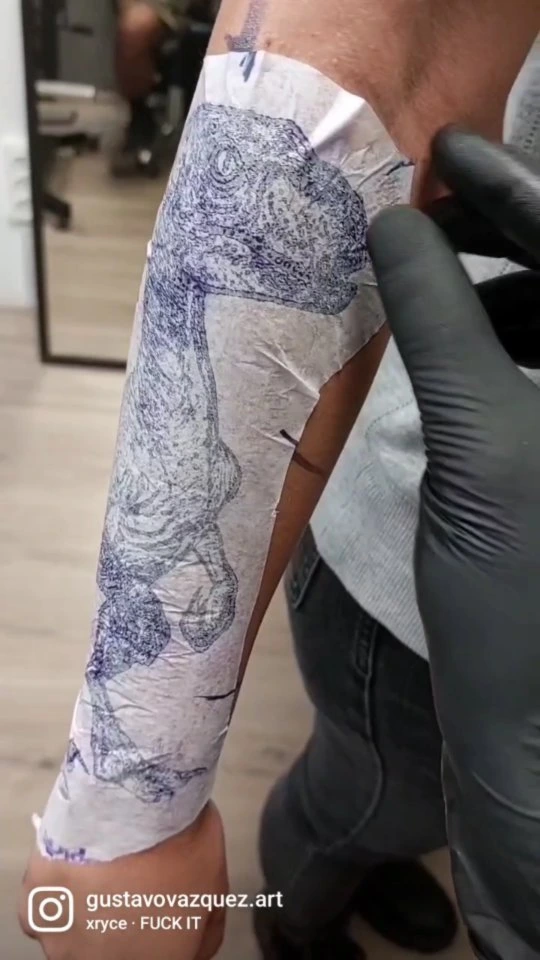 Velociraptor stencil placement on forearm (transfer paper)
