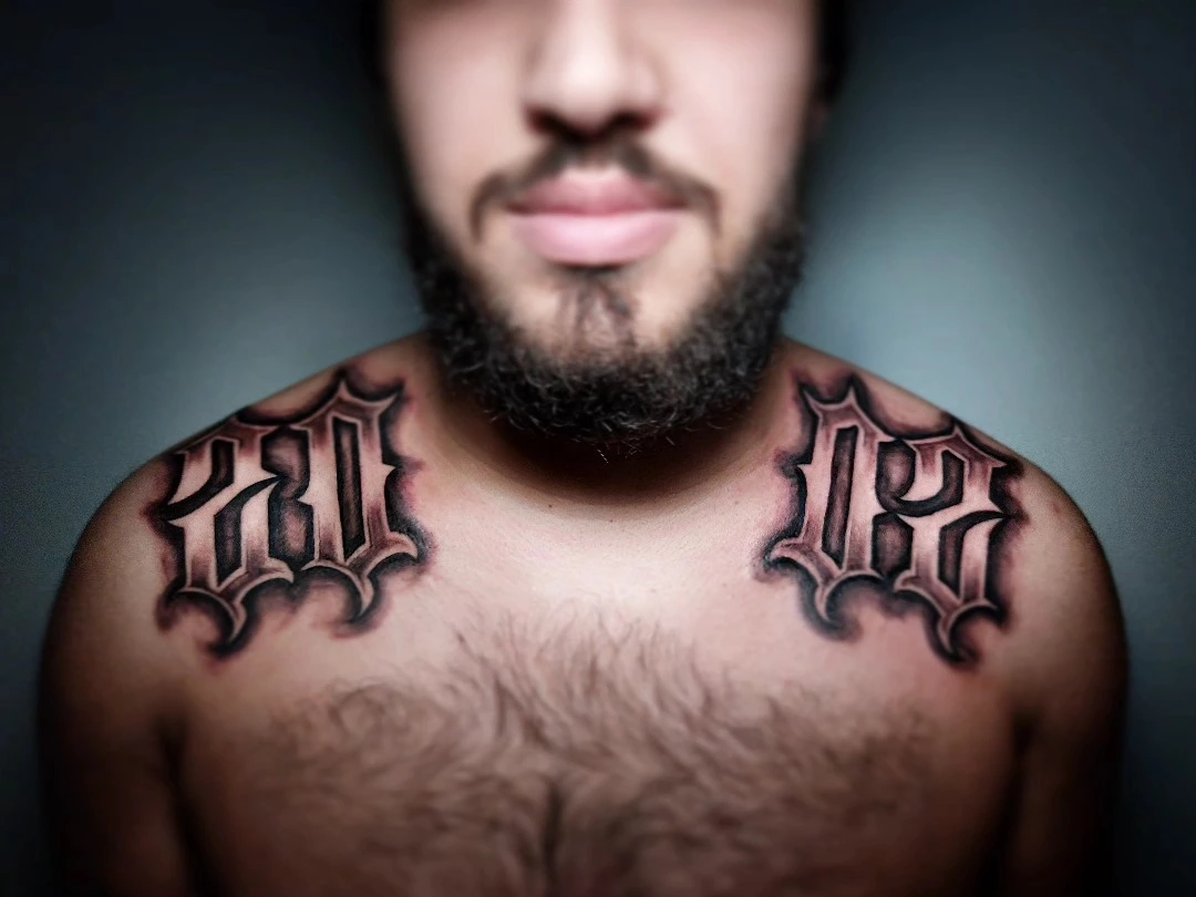 Paired '03/05' or year numerals on collarbones