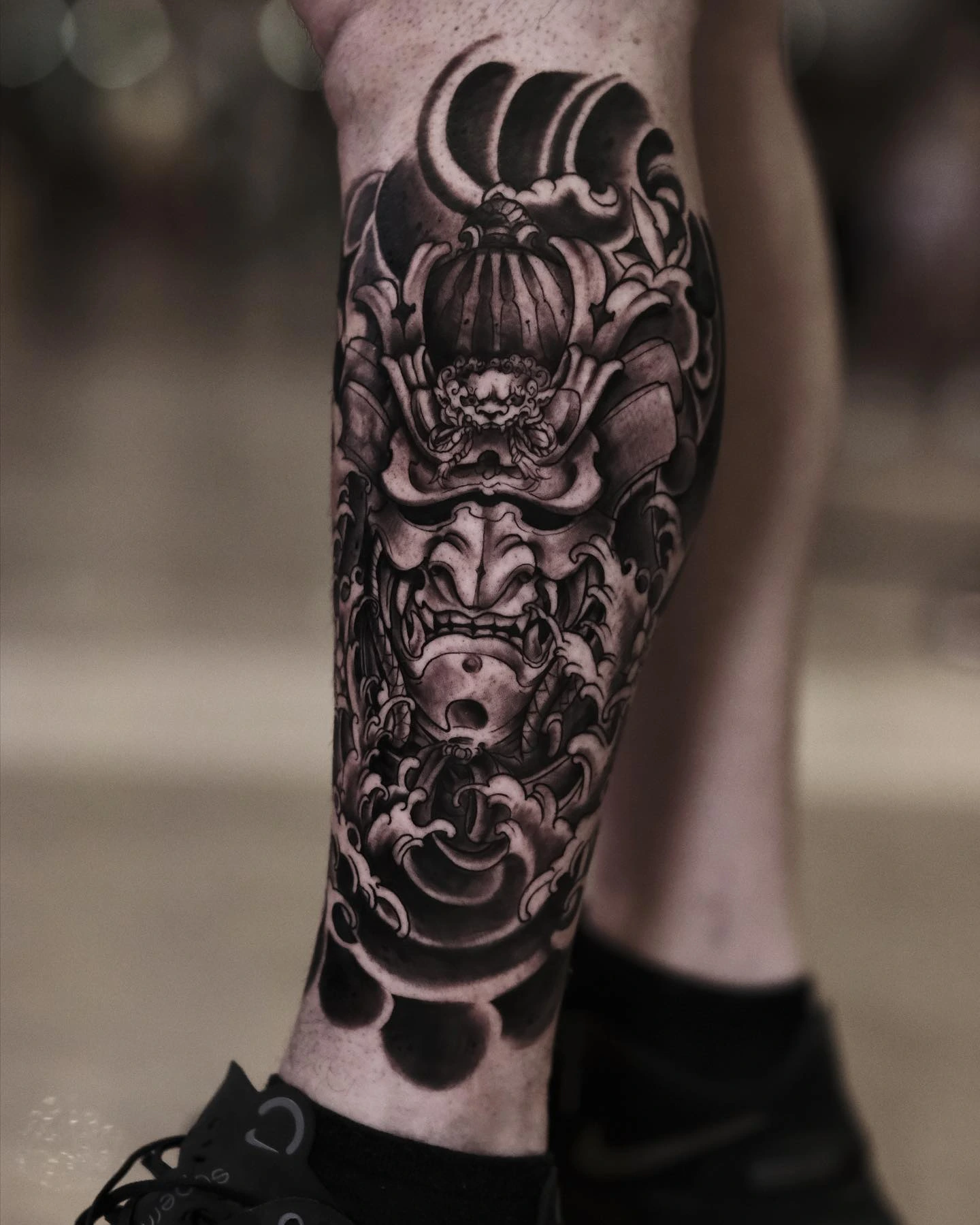 Samurai hannya mask in waves on calf