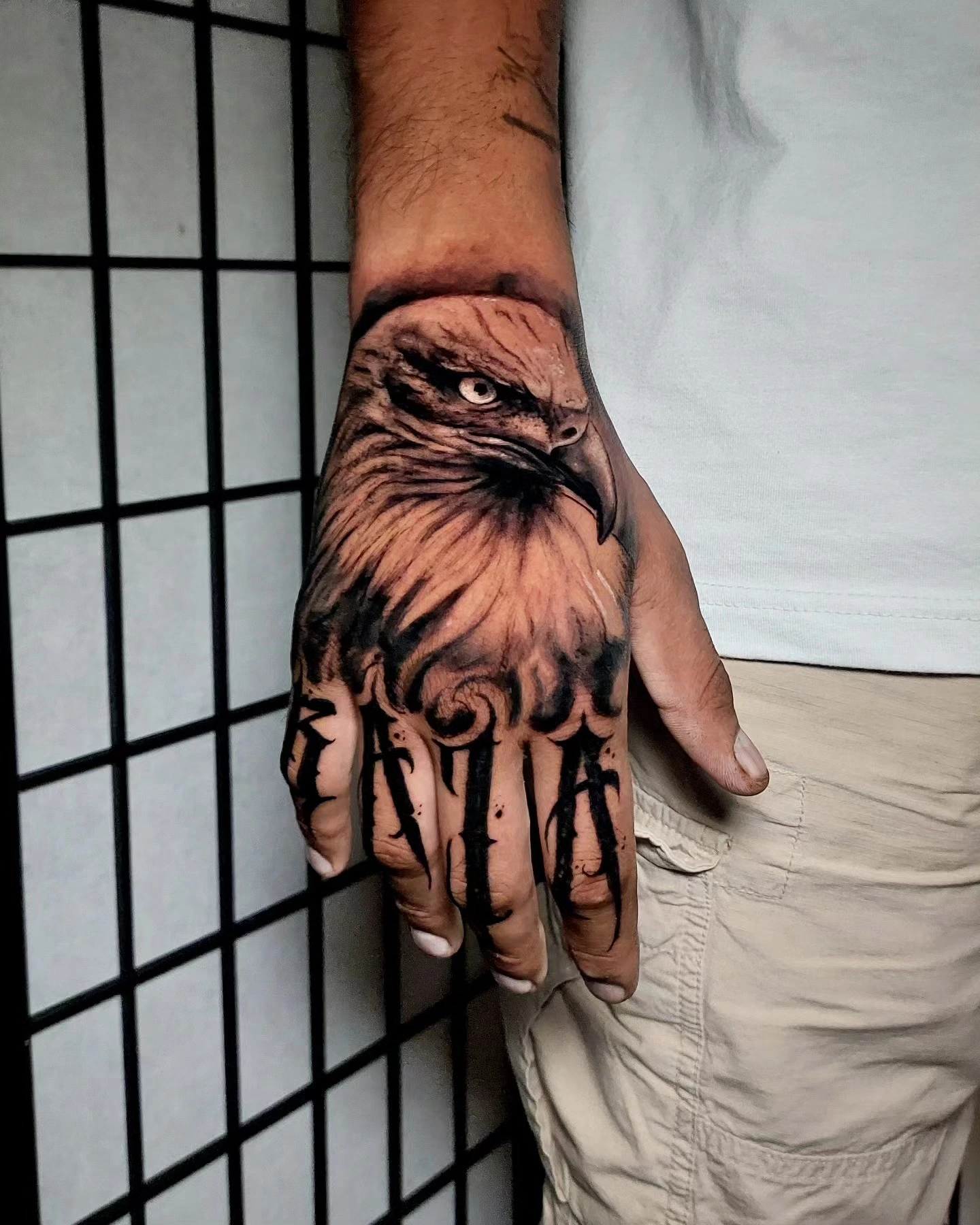 Photoreal eagle hand portrait with 'Katia' (or similar) script fingers