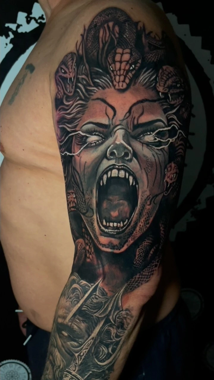 Screaming Medusa with snake hair + samurai/warrior figure below