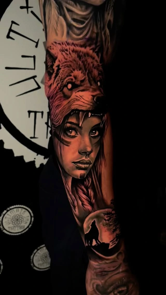 Female warrior with wolf-skull / wolf headdress and lone wolf scene below
