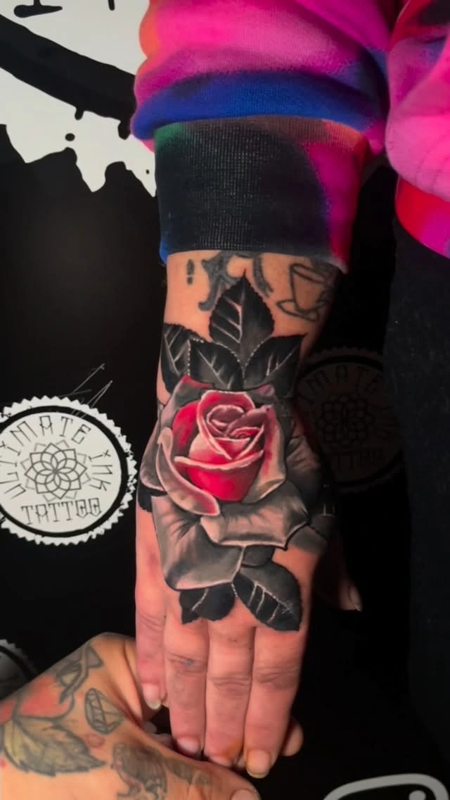 Photoreal red rose with B&G leaves over old hand tattoos (cover-up)