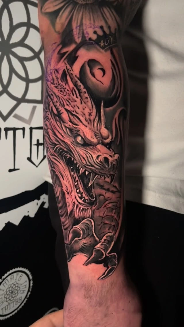 Roaring dragon head with crown above, claws below