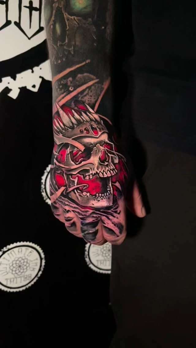 Bandit/skull crowned skull with red flames on hand, cover-up