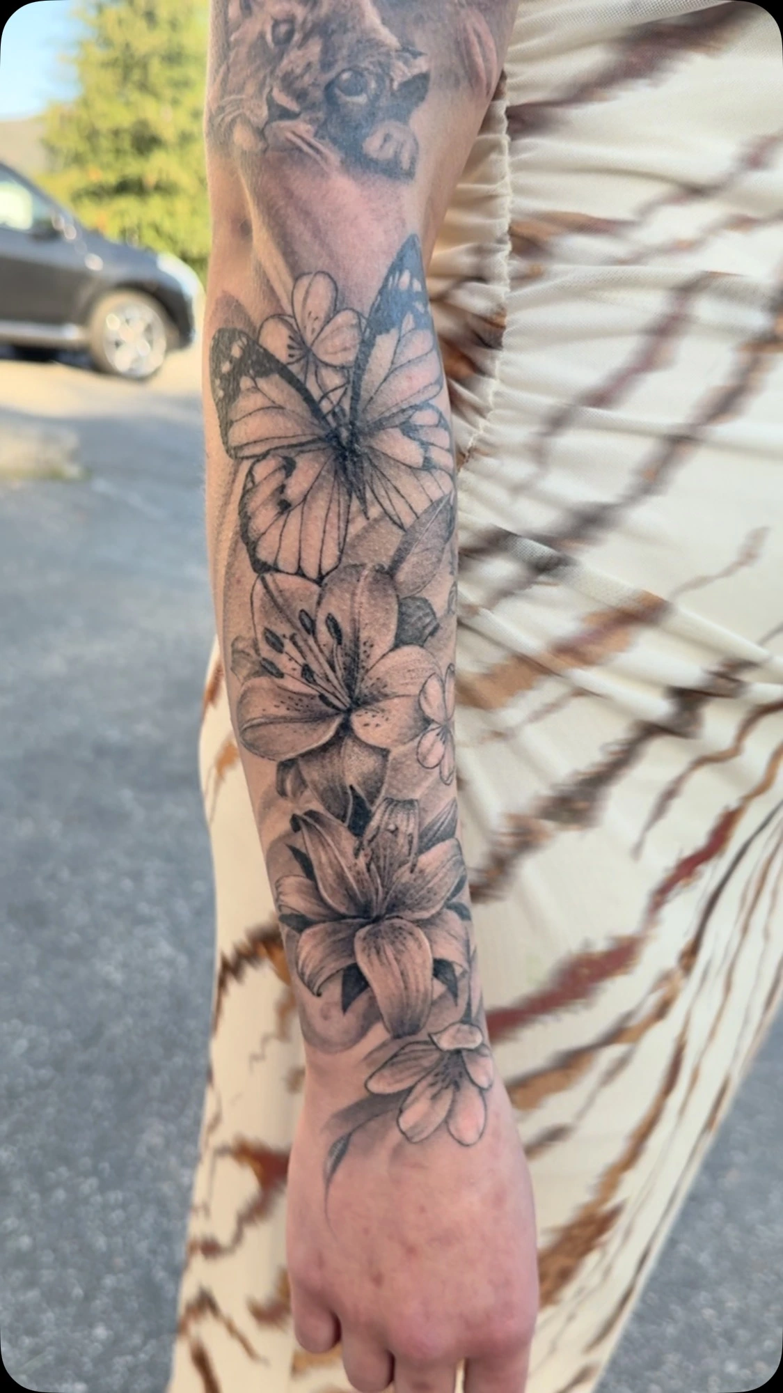 soft fineline floral sleeve with butterfly and lion peek above