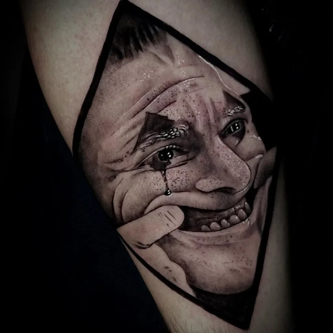 Joker face peeling open in diamond cartouche
